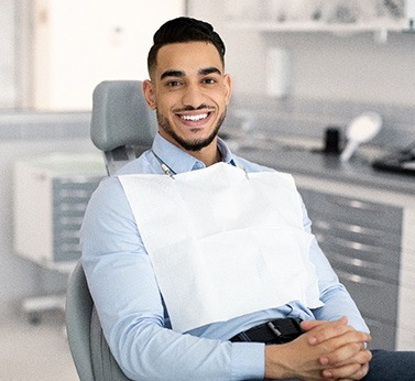Patient smiling while sitting in treatment chair