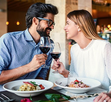 Couple smiling at each other on date in restaurant