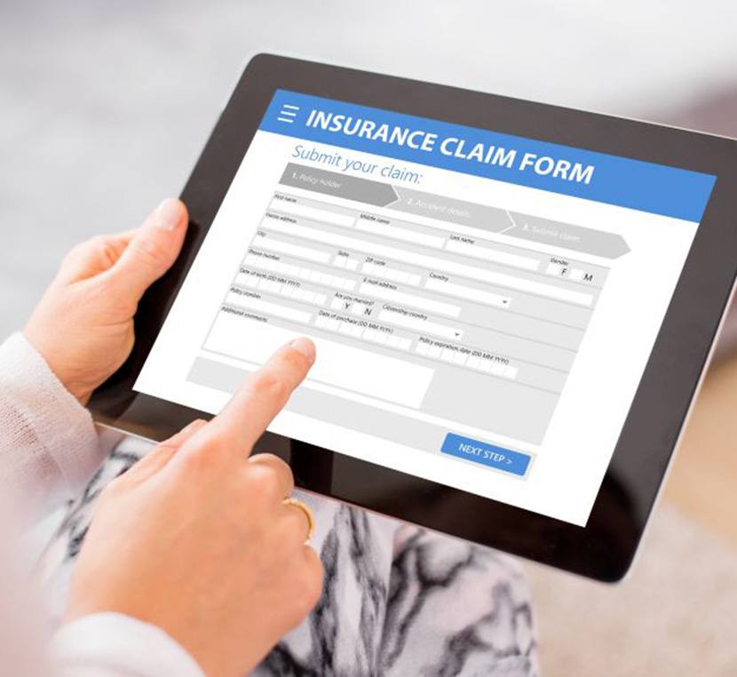 Person using tablet to fill out insurance claim form