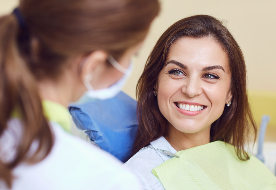 Patient at orthodontal exam, talking to doctor, smiling